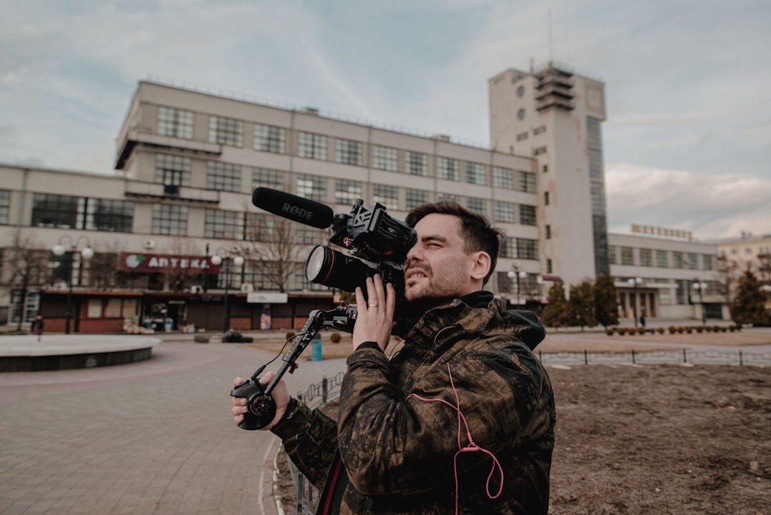 Television journalist reporting live outdoors with camera crew